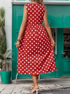 Back view of a red sleeveless A-line dress with white sun patterns in an outdoor setting