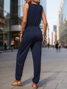 Rear view of a navy blue sleeveless jumpsuit with elastic waist and jogger cuffs