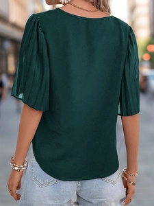 Close-up of the back view of a dark green puff sleeve blouse with pleated detail