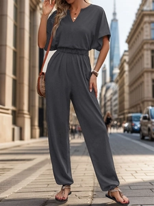 Detail of a dark gray short sleeve jumpsuit with elastic waist and wide leg design
