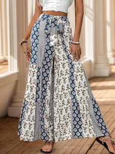 Detail of high waist wide-leg trousers with ethnic geometric prints and sash belt