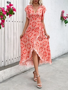Close-up of a floral wrap dress featuring a V-neck, ruffle sleeves, and asymmetric hemline