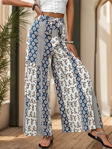 Detailed view of high-waisted wide-leg pants with bohemian ethnic print and waist tie