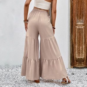 Women's high waist beige tiered flare trousers with elastic band and textured fabric