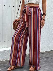 Detail of high waisted bohemian wide leg trousers with colorful ethnic stripe pattern