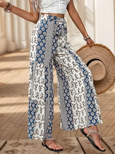 Detail of high waisted bohemian wide leg trousers with colorful patchwork prints