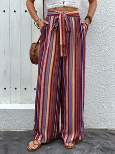 Detail showing high waist elastic band and ethnic geometric pattern on wide leg trousers