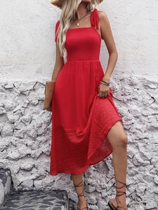 Detail of adjustable bow shoulder straps and square neckline on red summer midi dress