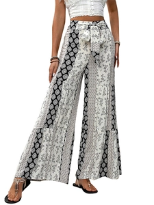 Detailed close-up of high-waist boho wide-leg trousers with patterned floral patchwork
