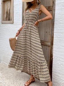 Detail of bohemian geometric print dress with drawstring waist and deep V-neckline