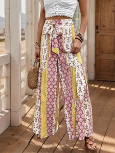 Detail of high waist bohemian wide leg trousers with floral patchwork and self-tie belt