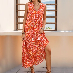 Detail of the V-neckline with white tassels on a tiered bohemian floral maxi dress