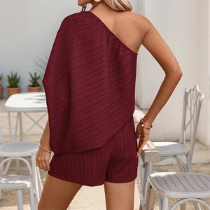 Deep wine red two-piece textured set with one-shoulder irregular top and high waist shorts