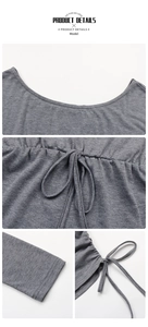 Détail de la robe en maille grise avec taille à cordon et fin et lacets décoratifs au bas