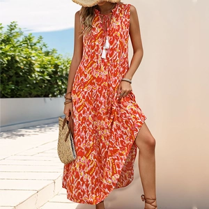 Detail of bohemian V-neck floral maxi dress with white tassel drawstrings and layered hem
