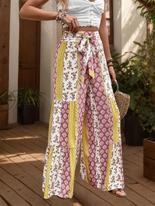 Detail of high waisted wide leg pants with ethnic print and drawstring bow tie