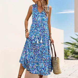 Detail of V-neck tiered maxi dress with blue bohemian print and white tassel drawstrings