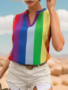 Detail shot of a V-neck sleeveless top featuring vibrant rainbow vertical stripes on fabric