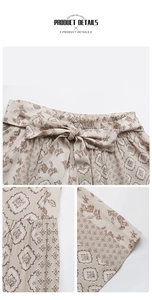 Detail view of ethnic floral high-waisted pants with smocked elastic waist and bow belt