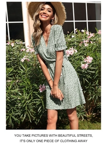 Close-up of green floral dress with V-neckline and puff sleeves in outdoor garden