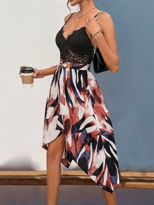 Detailed view of black lace bodice with eyelash trim and metal buckle belt on printed dress