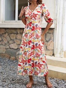 Outdoor shot of a V-neck floral midi dress with puff sleeves and button-up front