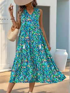 Detail of vibrant blue bohemian print on sleeveless maxi dress with tassel necklines