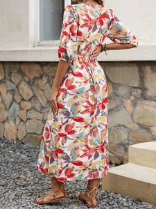 Detailed close-up of vibrant floral print and waist tie design on a summer dress