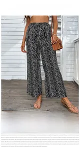 Detailed view of high waist elastic band on black and white floral wide leg trousers