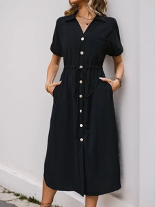 Detail of black short-sleeved shirt dress with lapel collar and drawstring waist
