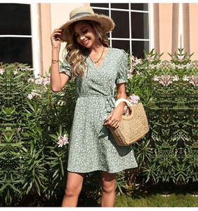 Detail view of the V-neck design and green floral print fabric on summer mini dress