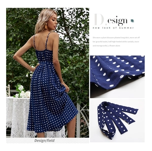 Detail of pleated polka dot midi dress with adjustable waist tie and premium fabric texture