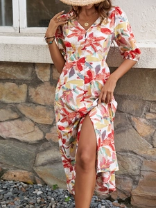 Detailed close-up of floral print v-neck dress with button front and side slit