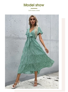 Detail of green floral V-neck maxi dress with bow tie and tiered ruffle hemline
