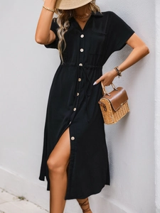 Detail of black button-down shirt dress featuring lapel collar and waist drawstring