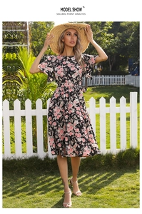 Detailed view of floral pleated dress with ruffle sleeves and waist tie in garden