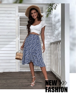 Detail of high-waist floral midi skirt with ruffle hem and white puff sleeve crop top