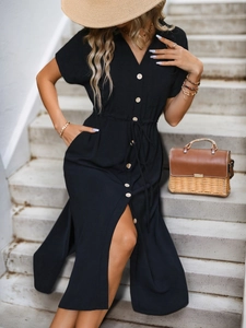 Detail of short sleeve black shirt dress with waist drawstring and side slit hemline