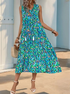 Detail of multi-colored bohemian print maxi dress with tiered skirt and tassel tie neckline