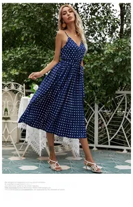 Detailed view of dark blue polka dot chiffon pleated dress with v-neck and waist tie
