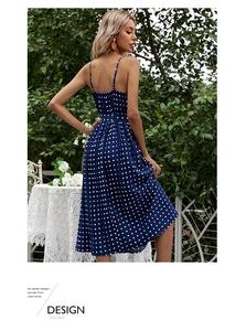Detailed view of the navy blue polka dot chiffon dress featuring fine pleated skirt texture