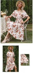 Detail view of floral pleated dress featuring ruffle sleeves and waist tie design