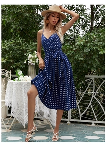 Detail of navy blue polka dot V-neck midi dress with waist tie and pleated skirt