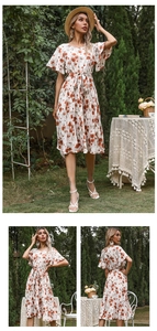 Detail view of floral pleated dress with ruffled sleeves and waist tie in a garden setting