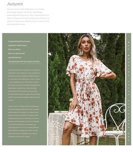 Detail view of floral pleated dress with ruffled sleeves and waist tie in garden setting