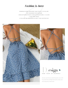 Detail of floral backless maxi dress featuring cross straps and ruffled hem design