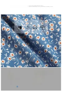 Close-up of blue floral dress fabric with daisy print and model size chart information