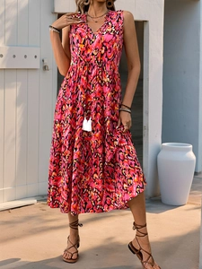 Detail of bohemian tiered floral dress with V-neckline and tassel drawstring waist