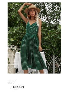 Detail of green polka dot chiffon dress with v-neck straps and a waist bow tie belt