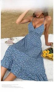 Detail of blue floral sundress with V-neck and tiered skirt on a beach picnic blanket